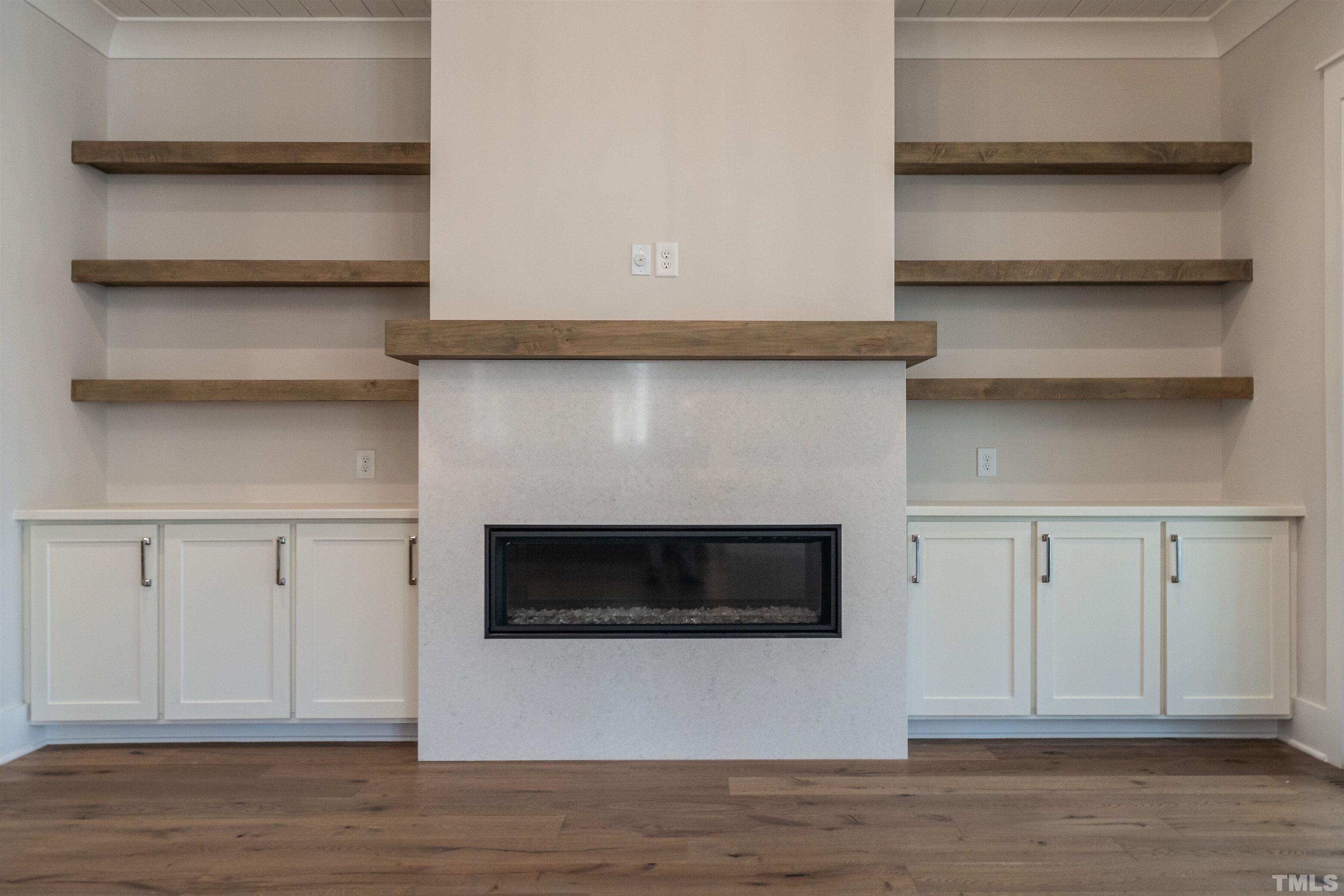 5425 Winding View Lane Raleigh, NC 27615 - Photo 13 of 54 a view of a livingroom with an empty space cabinets and a fireplace