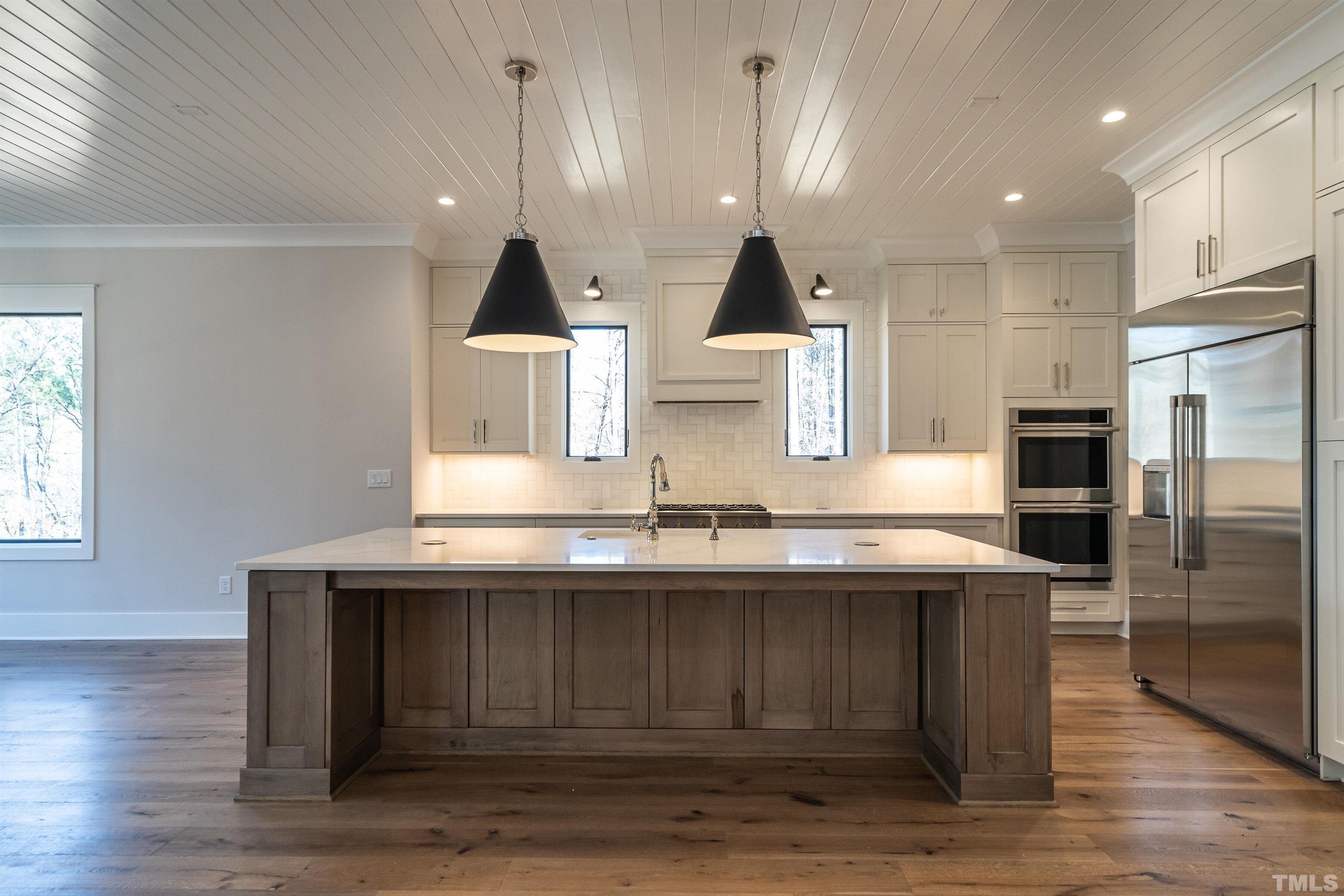 5425 Winding View Lane Raleigh, NC 27615 - Photo 18 of 54 a kitchen with stainless steel appliances granite countertop a sink a stove and a wooden floors