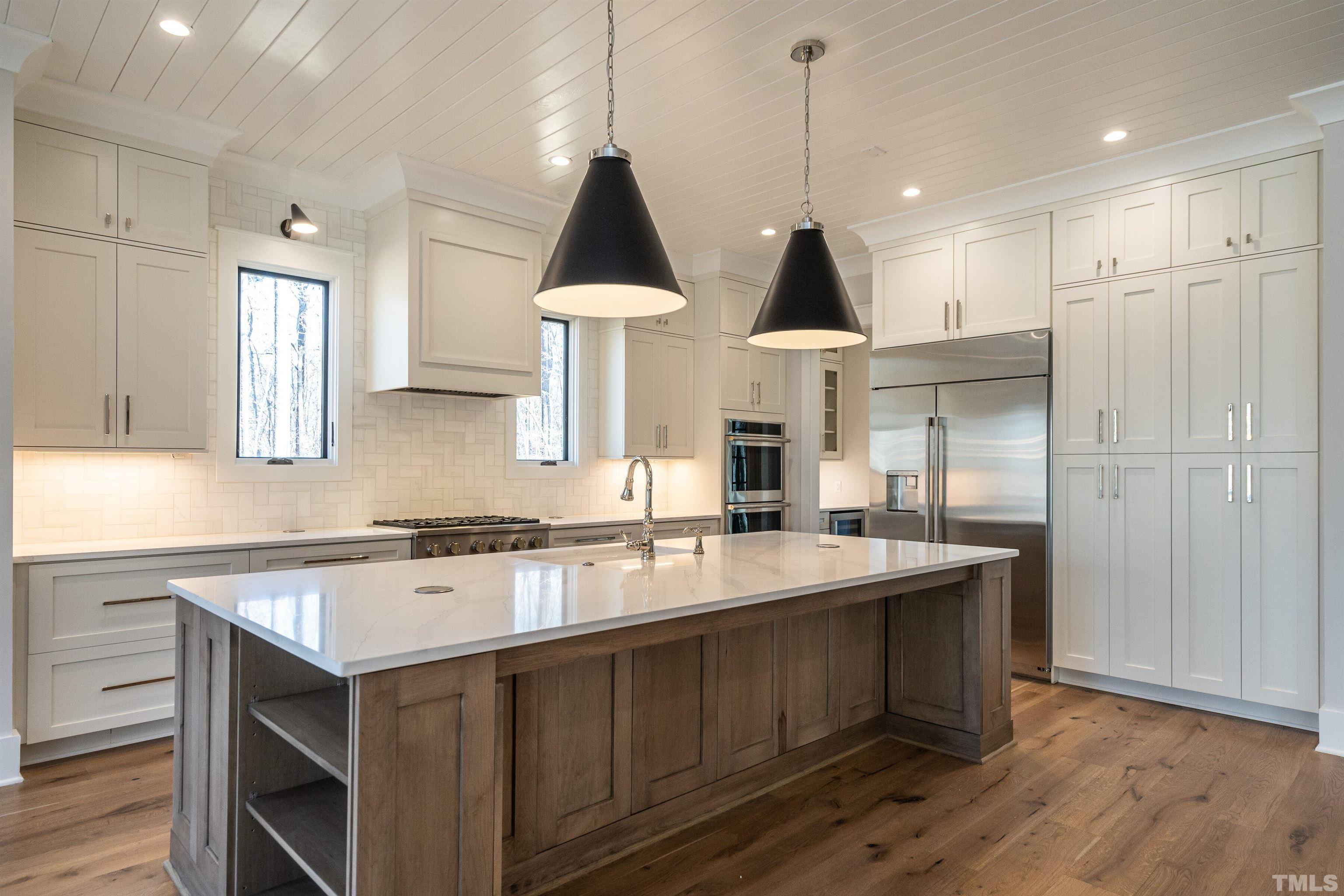 5425 Winding View Lane Raleigh, NC 27615 - Photo 19 of 54 a kitchen with stainless steel appliances a sink a stove a refrigerator and cabinets