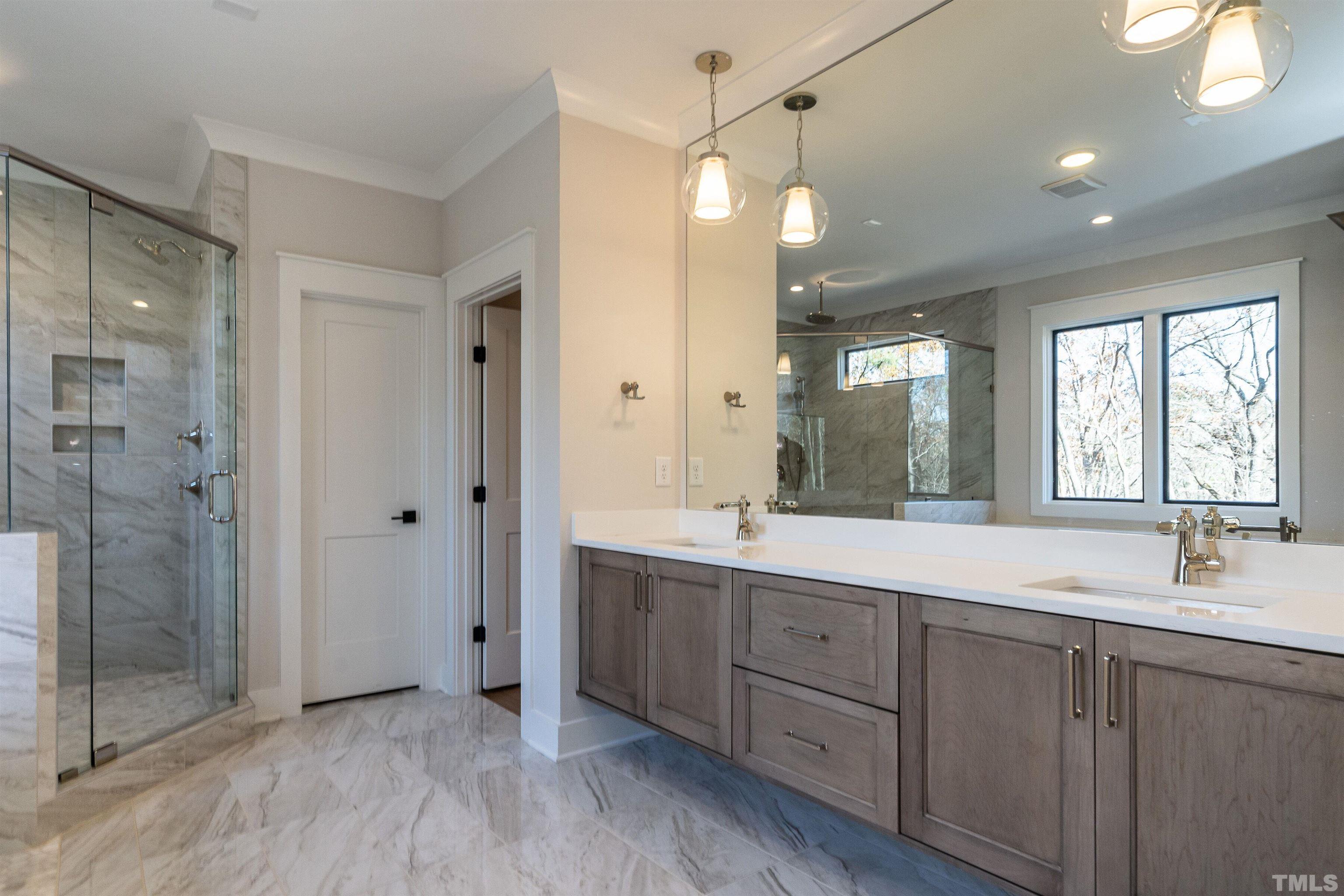 5425 Winding View Lane Raleigh, NC 27615 - Photo 34 of 54 a bathroom with a double vanity sink mirror and shower