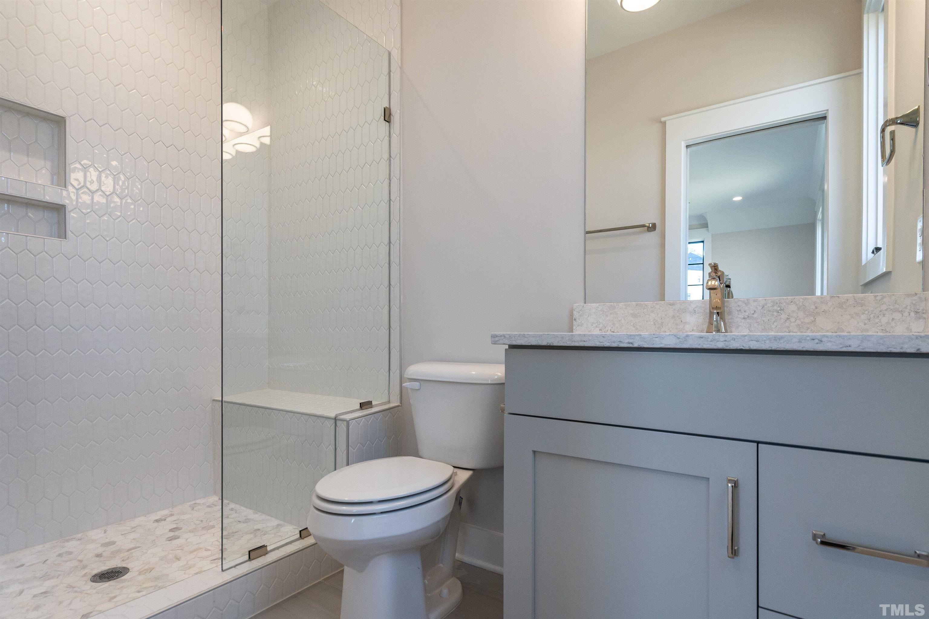 5425 Winding View Lane Raleigh, NC 27615 - Photo 41 of 54 a bathroom with a toilet a sink and shower