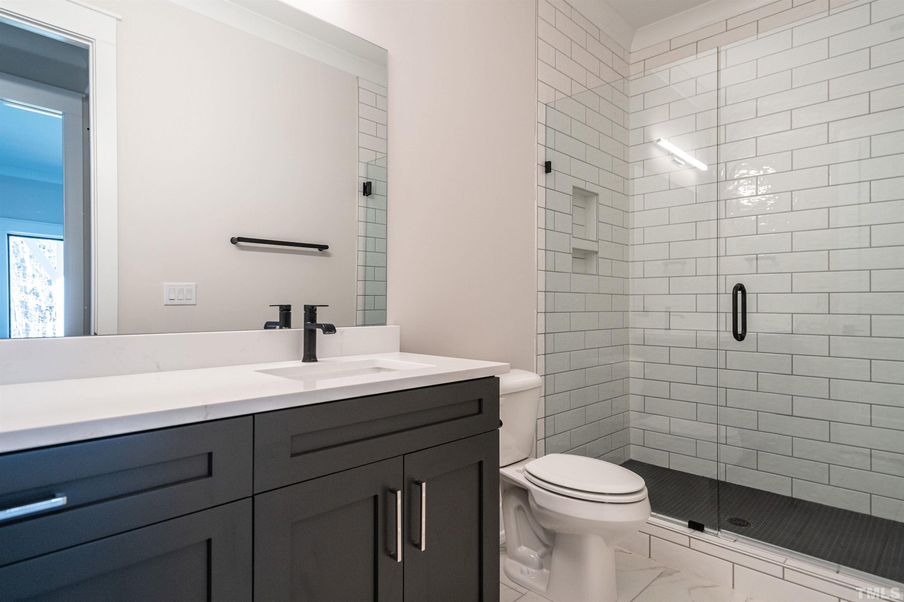 5425 Winding View Lane Raleigh, NC 27615 - Photo 50 of 54 a bathroom with a sink a toilet and shower