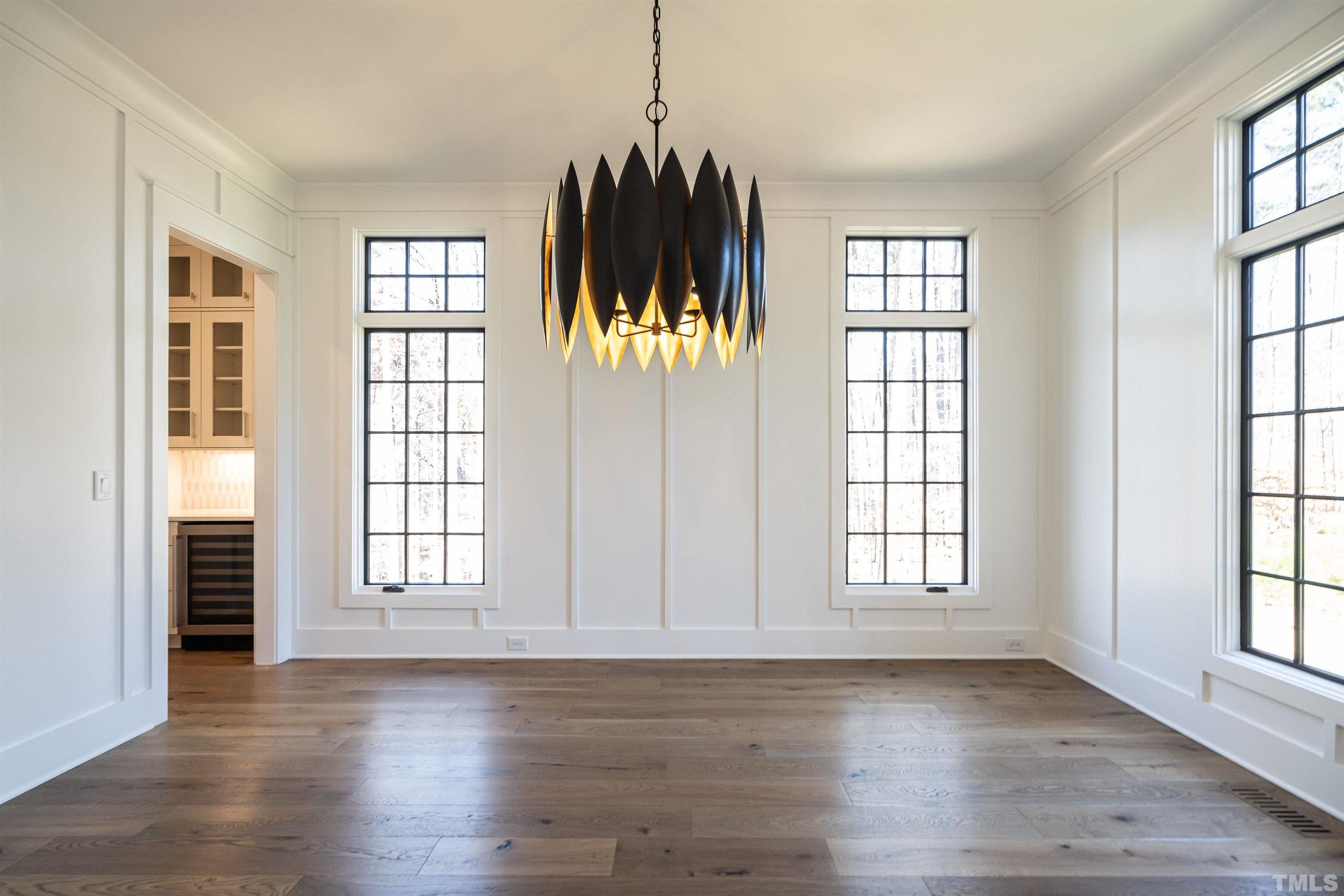5425 Winding View Lane Raleigh, NC 27615 - Photo 9 of 54 an empty room with wooden floor and windows