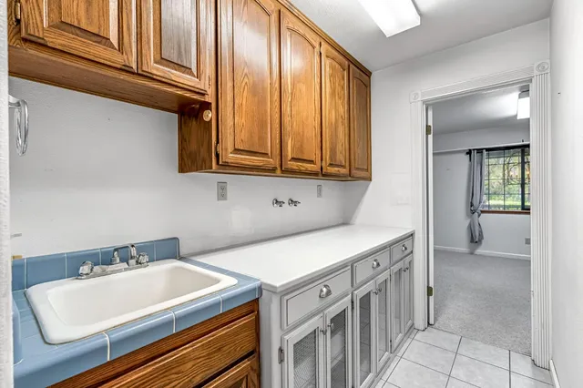 wooden floor with chandelier fan and windows in a room