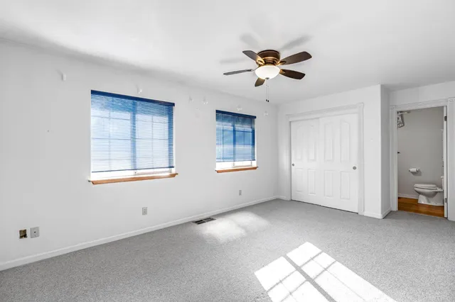 a bathroom with a double vanity sink toilet mirror and bathtub