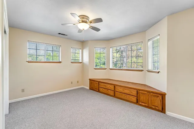 a view of a house with a yard and sitting area