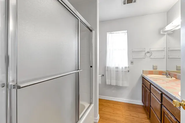 a kitchen with a refrigerator and a stove top oven