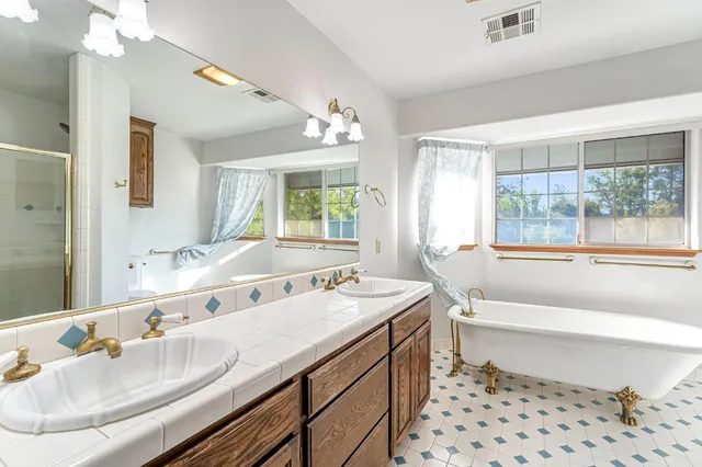 a view of a kitchen with a sink and refrigerator
