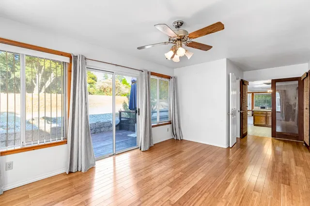 an aerial view of residential house with outdoor space and trees all around
