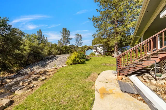 an aerial view of a house with a yard and garden