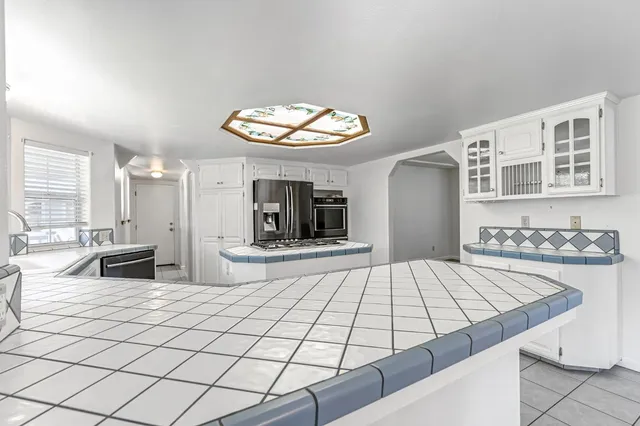 a kitchen with cabinets and window