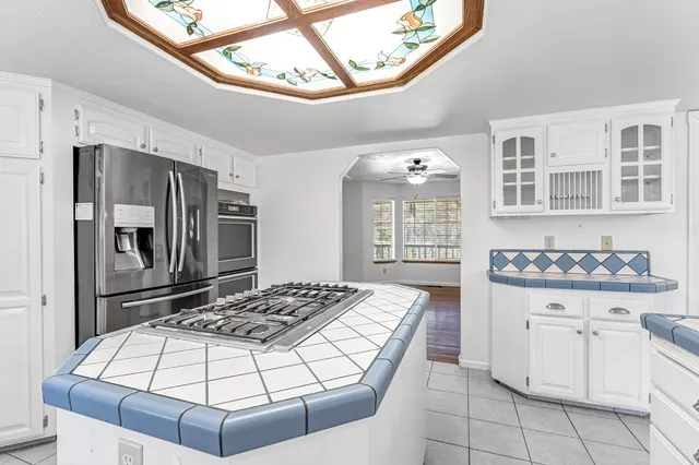 a kitchen with cabinets and window