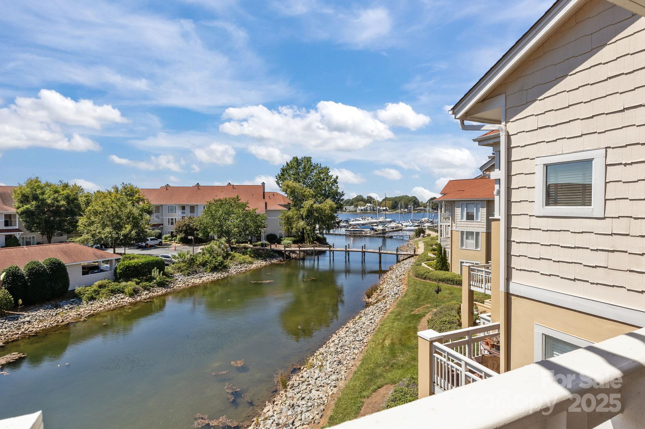 18009 Kings Point Drive, Unit I Cornelius, NC 28031 - Photo 1 of 47 a view of a lake with a balcony