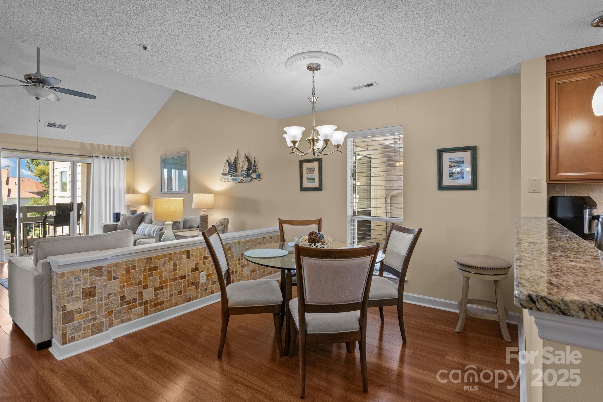 18009 Kings Point Drive, Unit I Cornelius, NC 28031 - Photo 13 of 47 a view of a dining room with furniture window and wooden floor