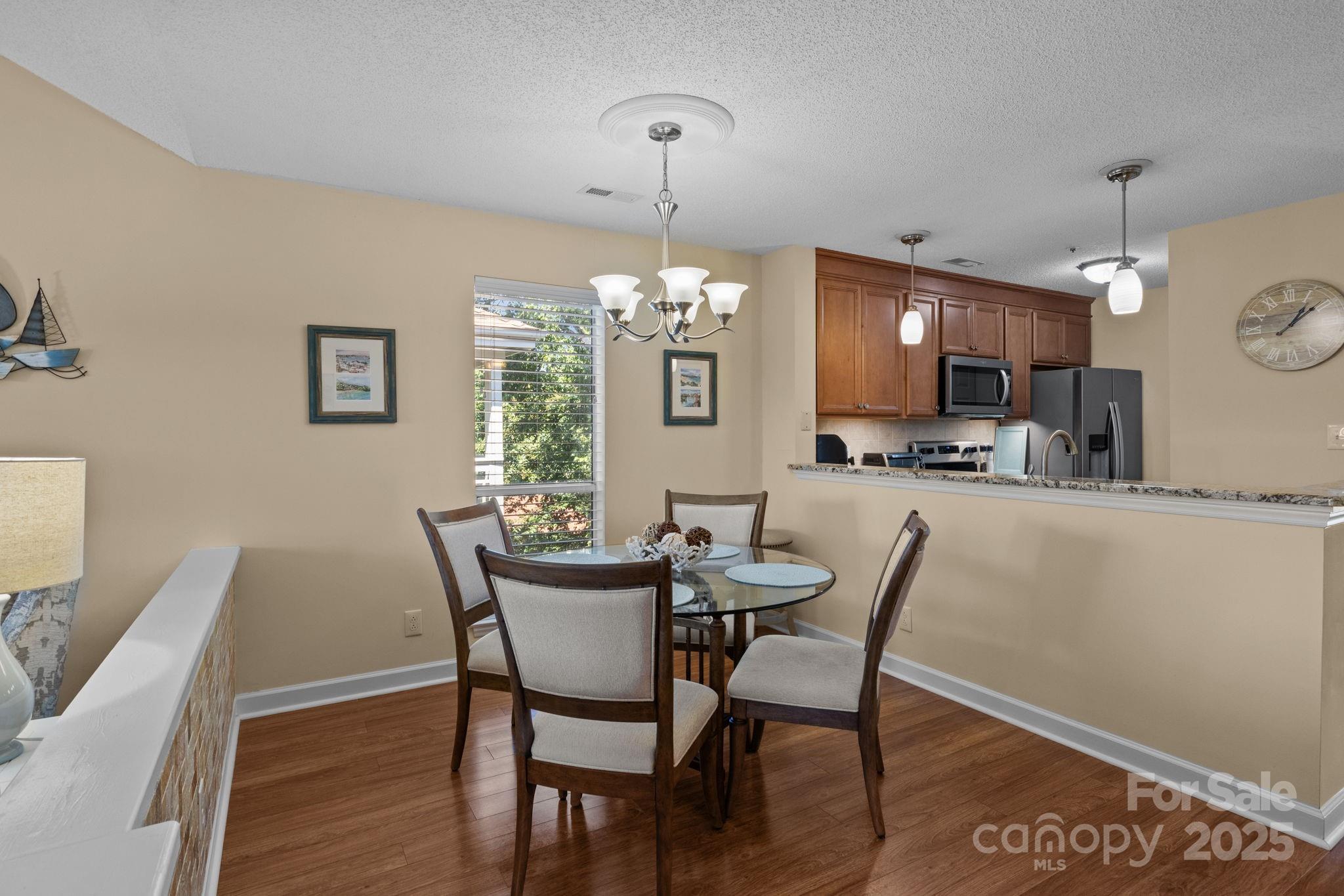 18009 Kings Point Drive, Unit I Cornelius, NC 28031 - Photo 14 of 47 a view of a dining room with furniture window and wooden floor
