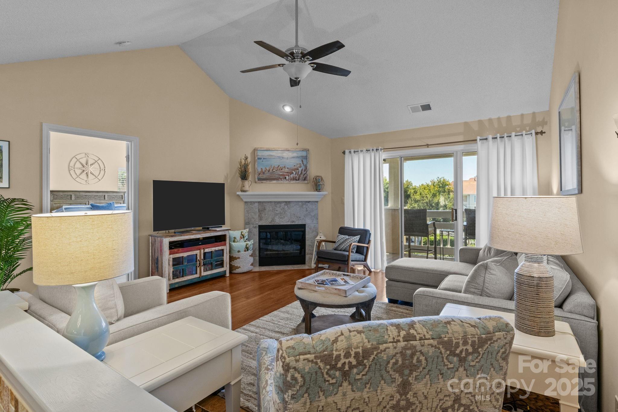 18009 Kings Point Drive, Unit I Cornelius, NC 28031 - Photo 17 of 47 a living room with furniture a fireplace and a flat screen tv