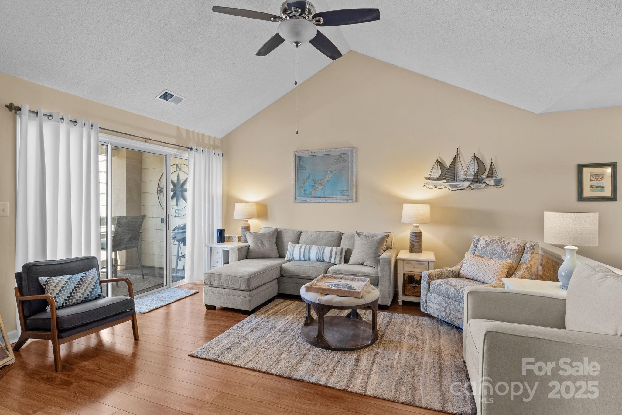18009 Kings Point Drive, Unit I Cornelius, NC 28031 - Photo 18 of 47 a living room with furniture and a large window