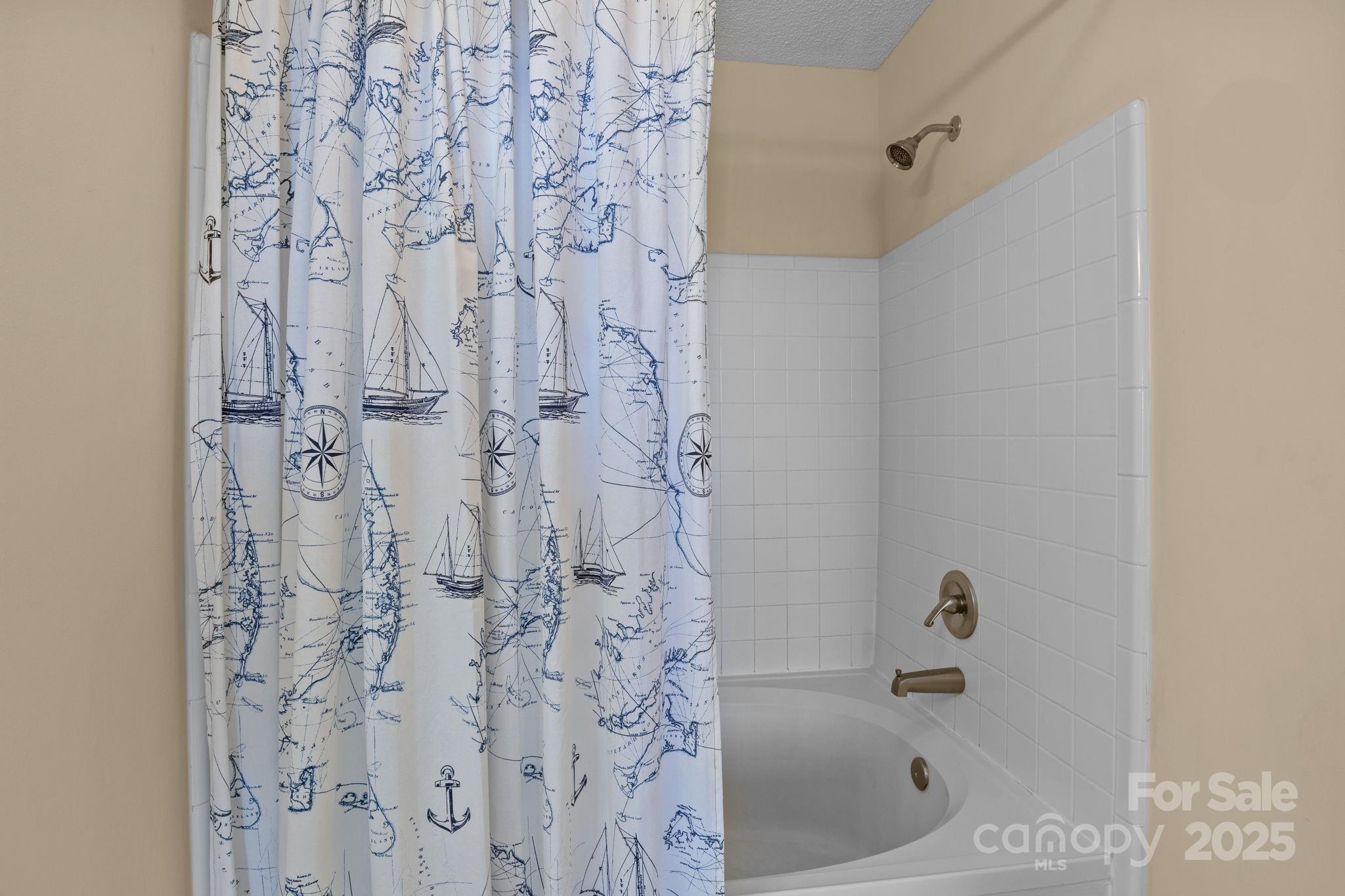 18009 Kings Point Drive, Unit I Cornelius, NC 28031 - Photo 22 of 47 a bathroom with a bathtub and shower