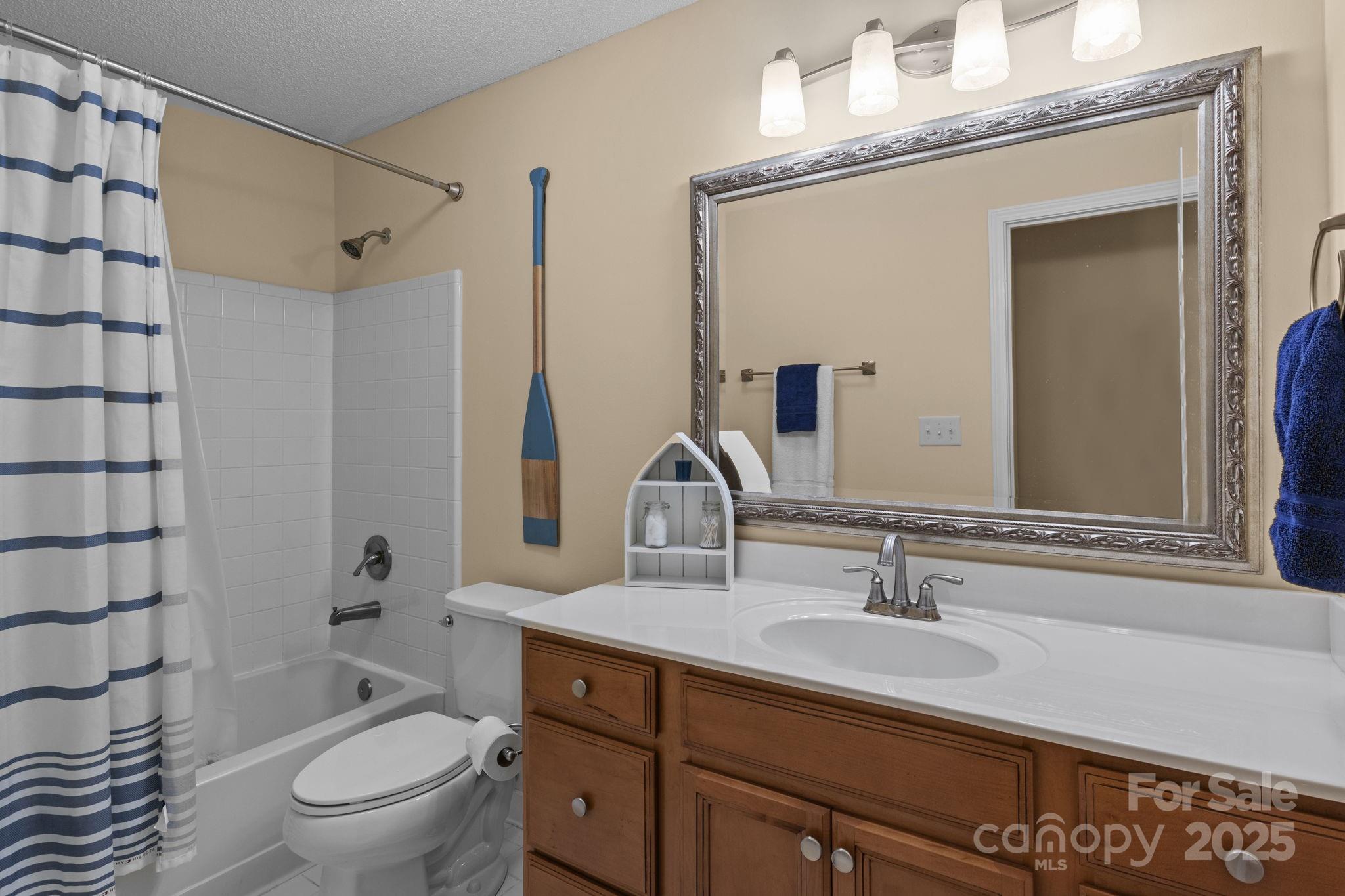 18009 Kings Point Drive, Unit I Cornelius, NC 28031 - Photo 25 of 47 a bathroom with a granite countertop sink a toilet and shower