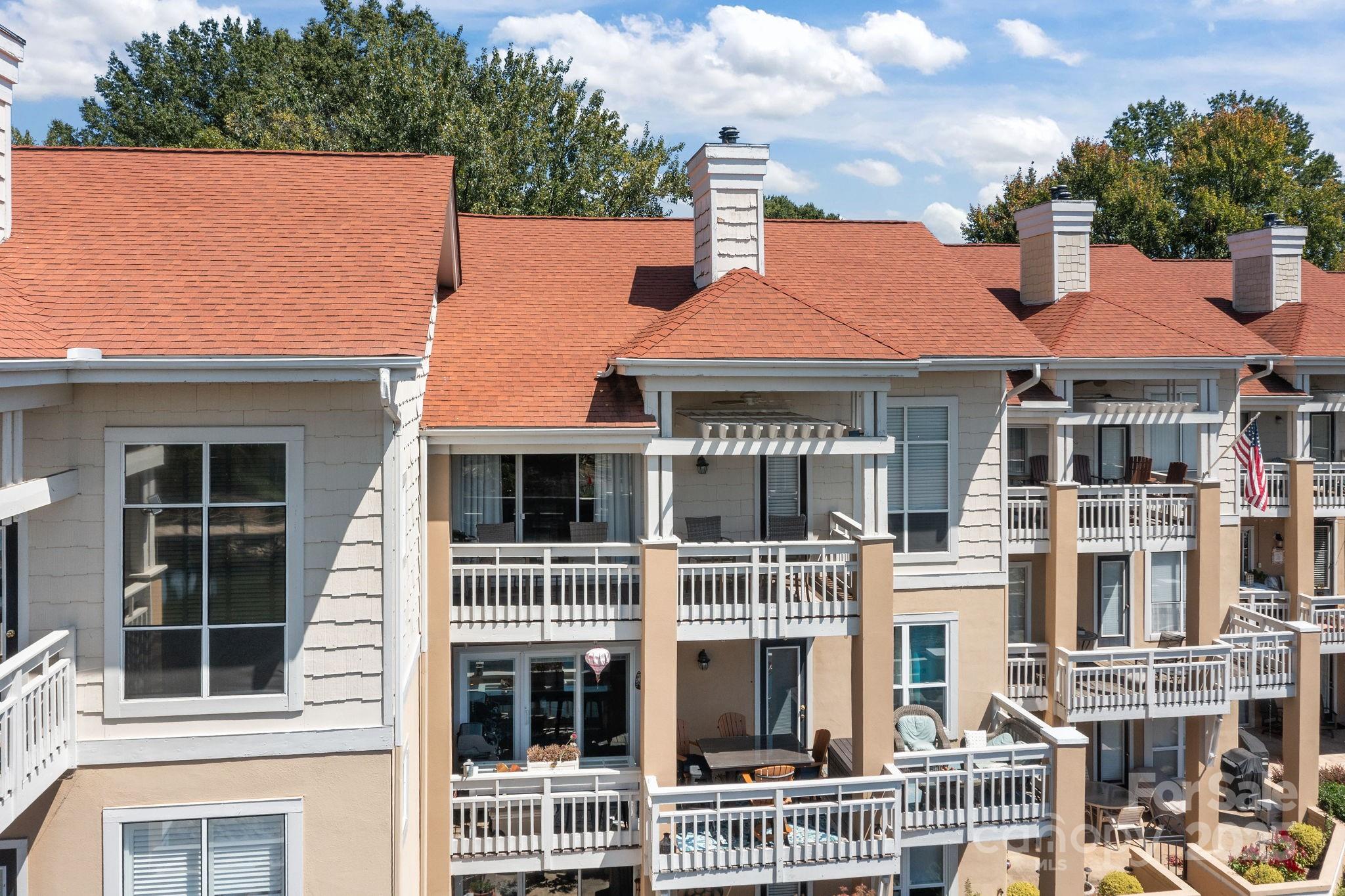 18009 Kings Point Drive, Unit I Cornelius, NC 28031 - Photo 35 of 47 a front view of a residential houses with yard