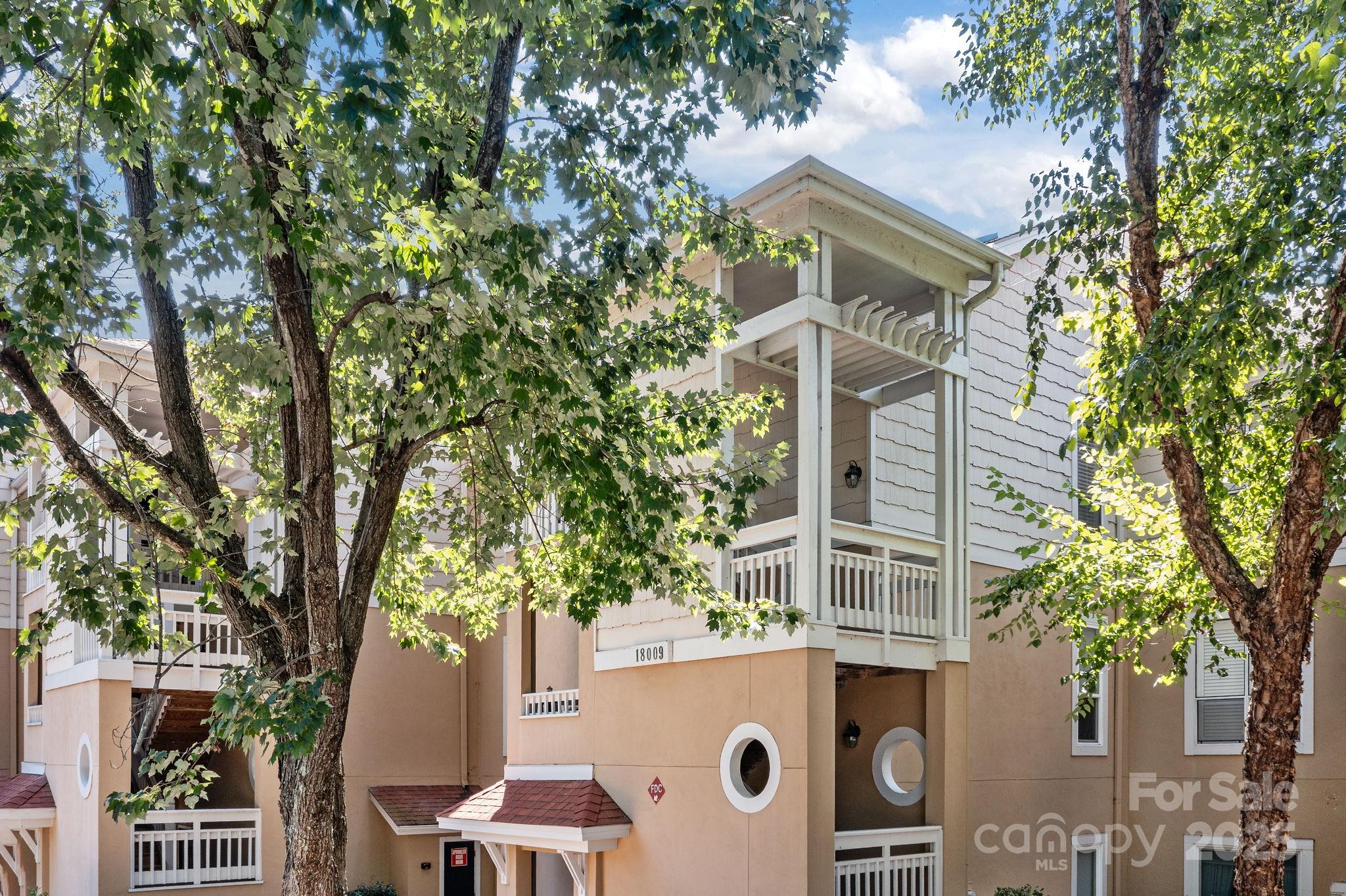 18009 Kings Point Drive, Unit I Cornelius, NC 28031 - Photo 37 of 47 front view of a house with a tree