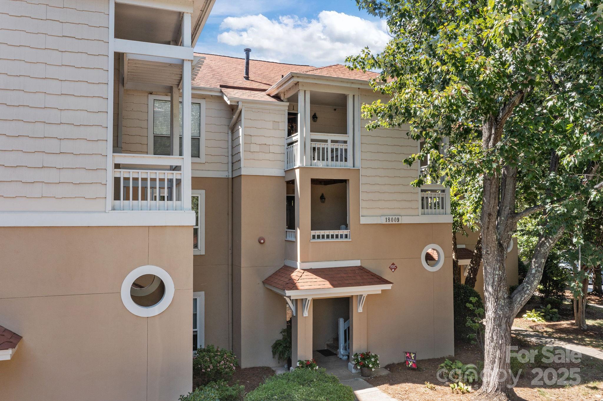 18009 Kings Point Drive, Unit I Cornelius, NC 28031 - Photo 38 of 47 a front view of a house with a yard