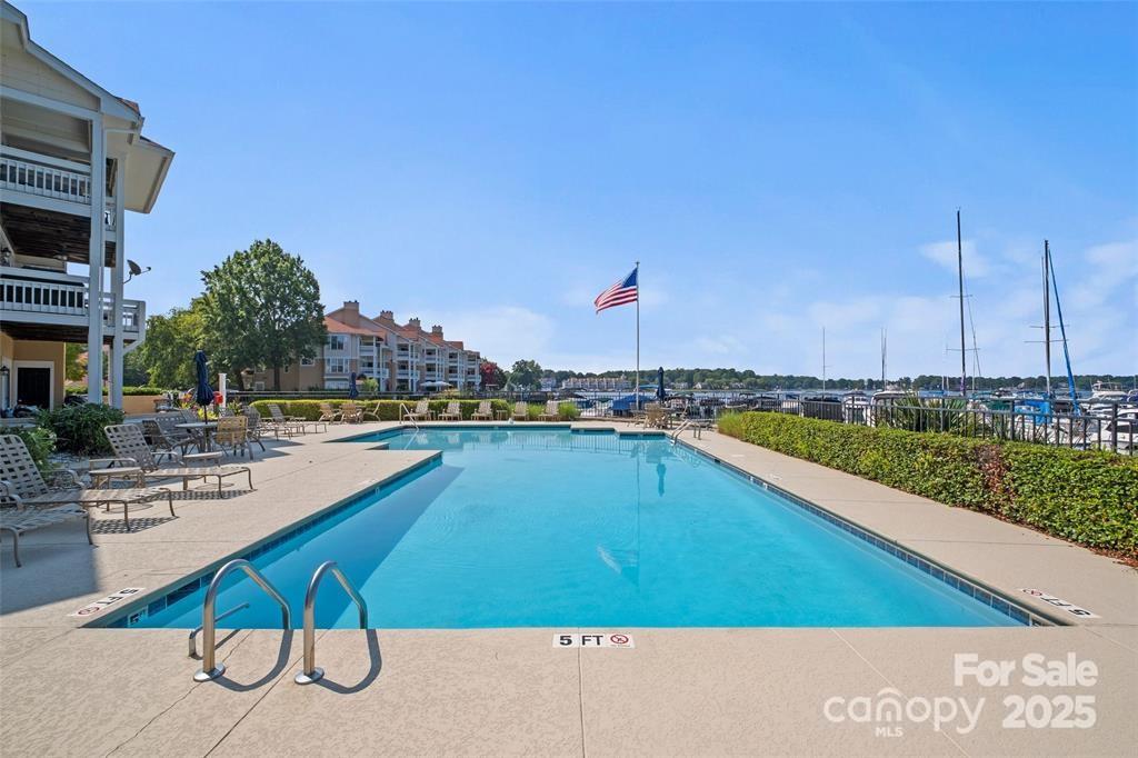 18009 Kings Point Drive, Unit I Cornelius, NC 28031 - Photo 42 of 47 a view of a swimming pool with chairs