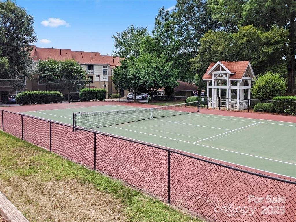 18009 Kings Point Drive, Unit I Cornelius, NC 28031 - Photo 43 of 47 a view of a tennis ground with large trees