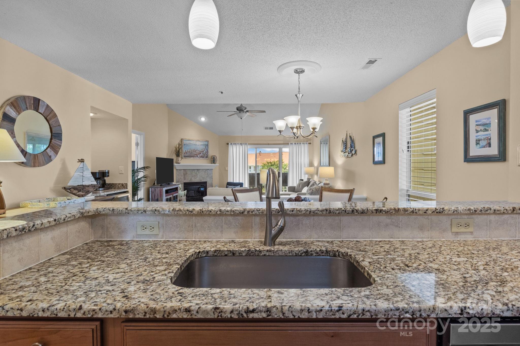 18009 Kings Point Drive, Unit I Cornelius, NC 28031 - Photo 6 of 47 a kitchen with a sink a counter top space and living room view