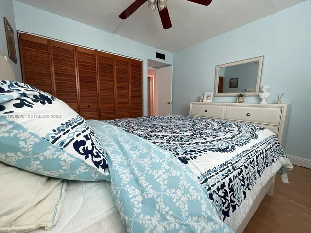 a kitchen with stainless steel appliances granite countertop a stove a microwave and a white cabinets