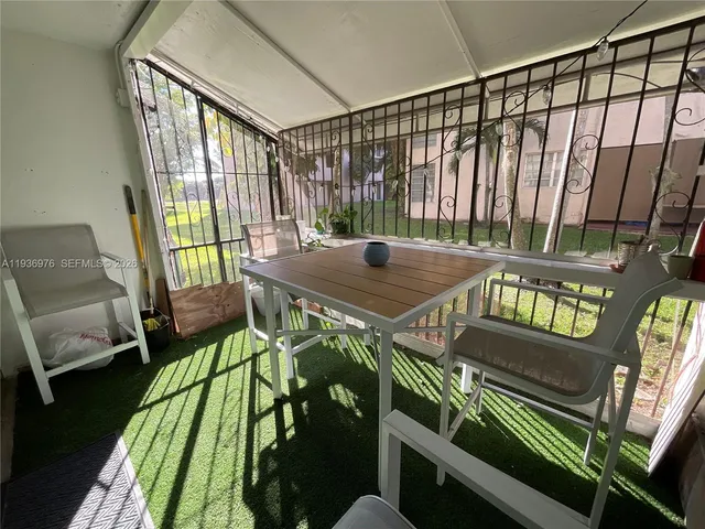 a bedroom with a bed and a view of kitchen