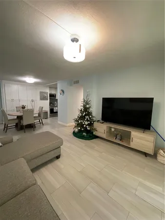 a bedroom with a bed and a chandelier fan