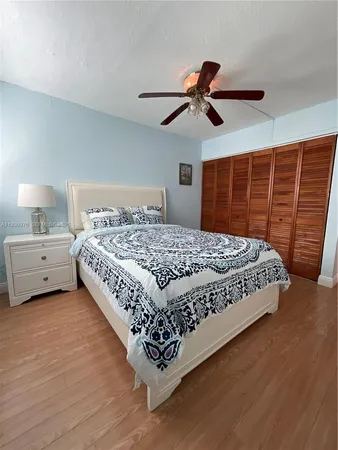 a bathroom with a toilet sink a mirror and shower