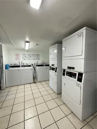 a bedroom with a bed and a view of kitchen