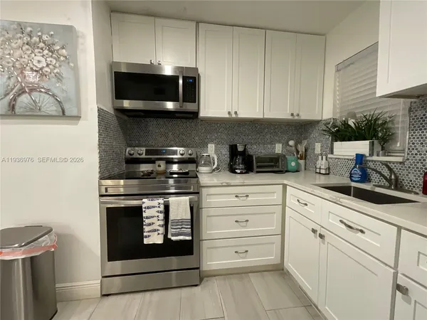 a kitchen with a sink and cabinets
