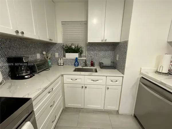 a kitchen with a refrigerator and a sink