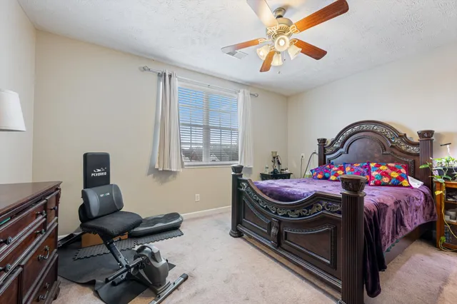 a bedroom with bed and a window