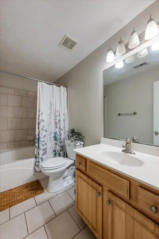 a bathroom with a double vanity sink toilet and shower