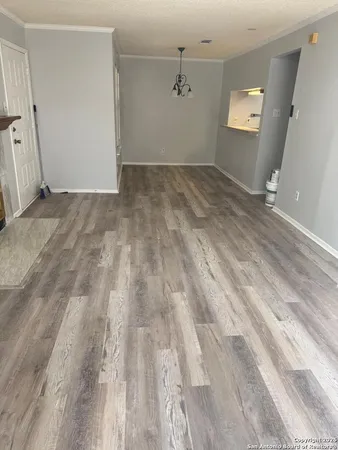 a view of a room with wooden floor and fan