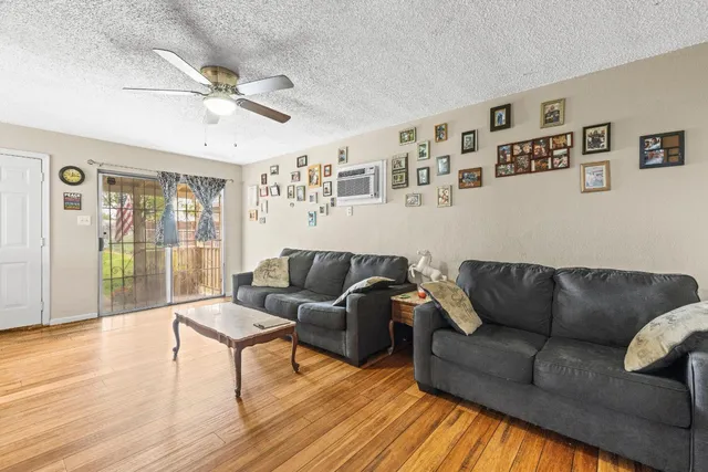 a living room with furniture and wooden floor