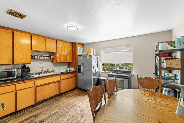 a kitchen with stainless steel appliances granite countertop sink stove top oven and cabinets