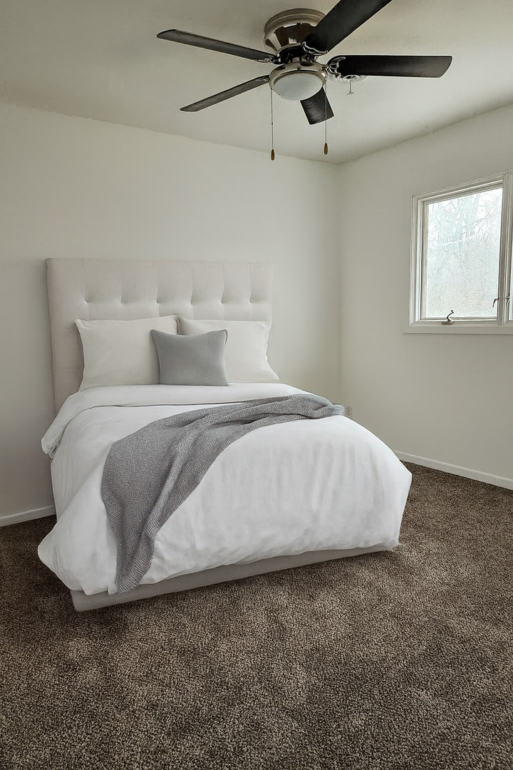 3424 Kimberly Downs Road Davenport, IA 52807 - Photo 6 of 11 a large bed sitting in a room next to a window