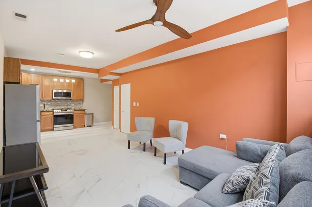 a living room with furniture and kitchen view
