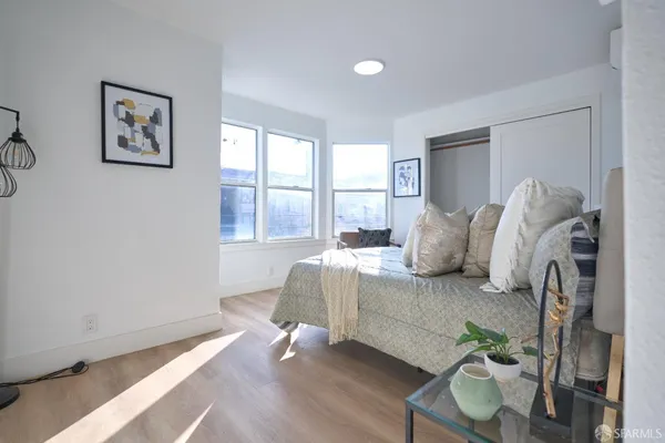 a bedroom with a bed and a window