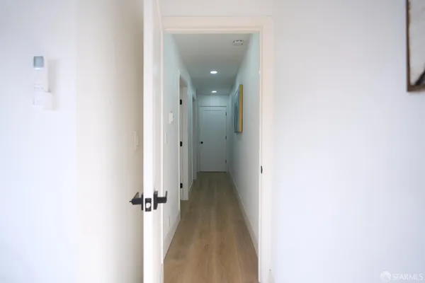 a bedroom with a bed table and a chair