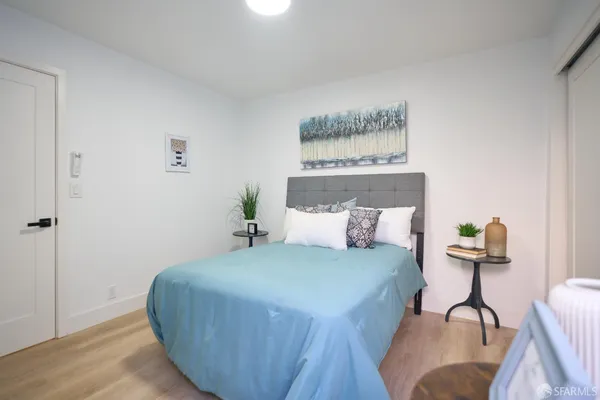 a bedroom with a bed and a potted plant