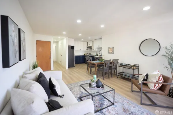 a living room with furniture dining table and a potted plant