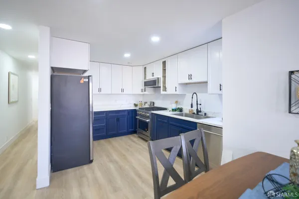 a kitchen with kitchen island granite countertop a sink stainless steel appliances and cabinets