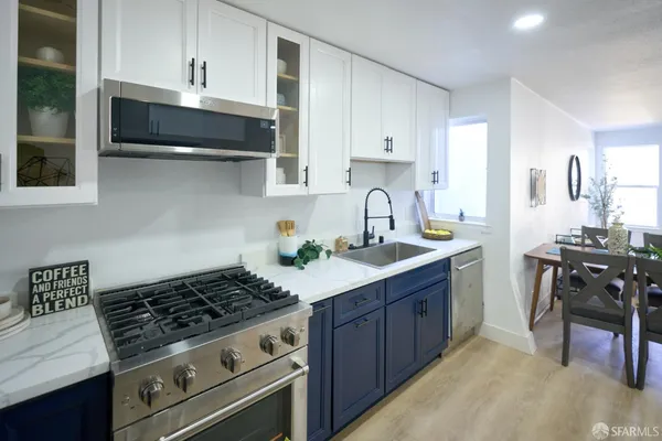 a kitchen with stainless steel appliances granite countertop a sink and cabinets