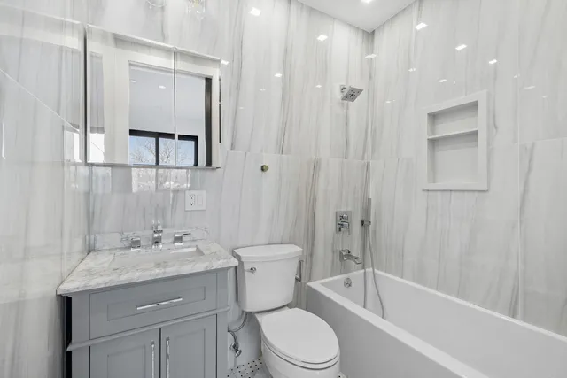 a bedroom with furniture and a floor to ceiling window